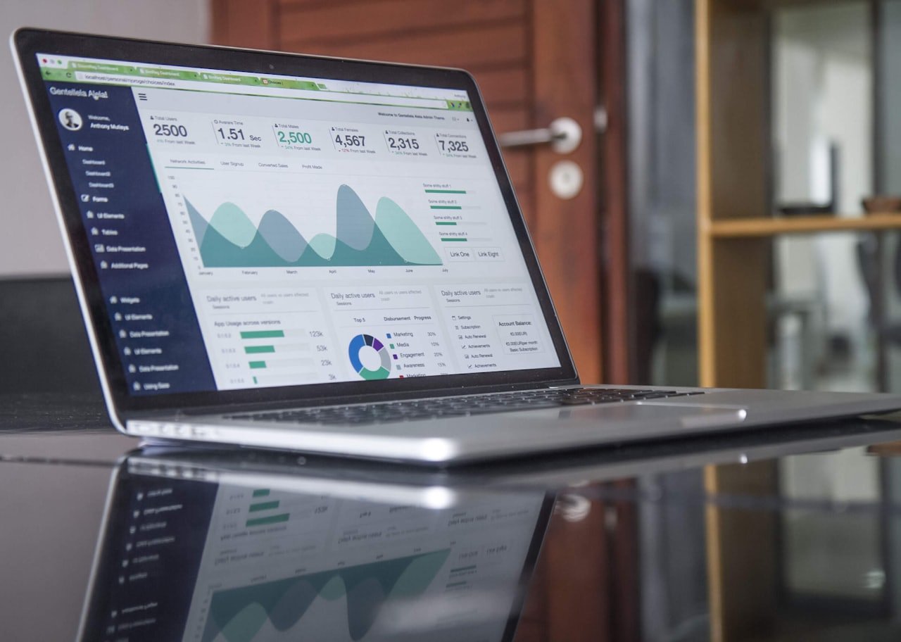 Laptop showing organic traffic graphs climbing on an SEO analytics dashboard