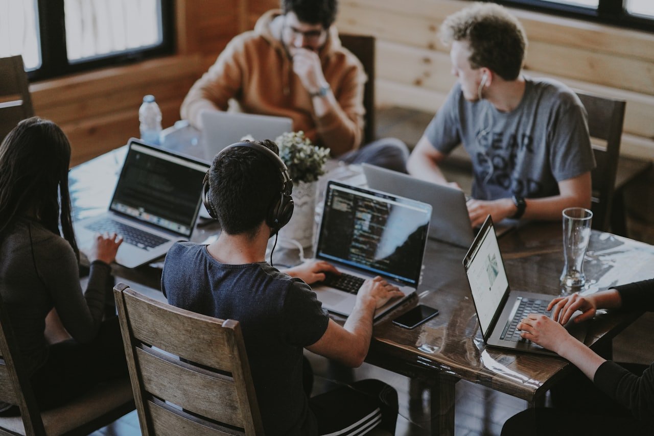 Editorial team collaborating on a content and SEO strategy across laptops